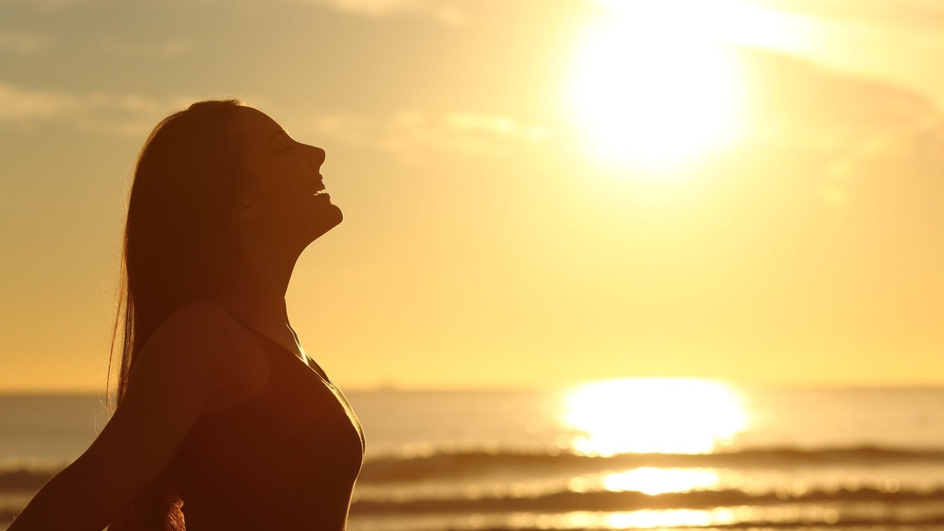 woman-free-with-ocean-sunset-e1562057767673